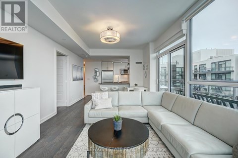 A living room with a white couch and a coffee table.