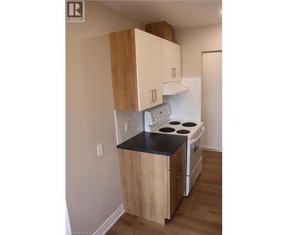 A kitchen with a stove and cabinets.