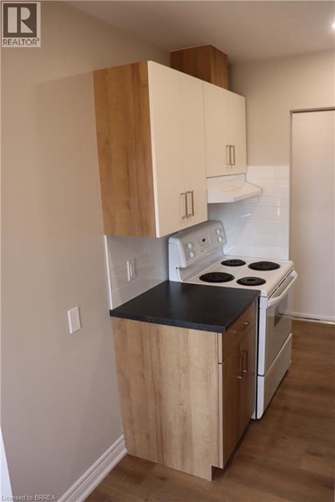 A kitchen with a stove and cabinets.