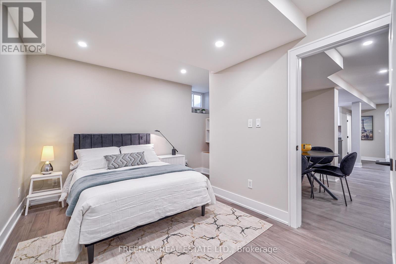 A bedroom with a large bed and a chair in it.