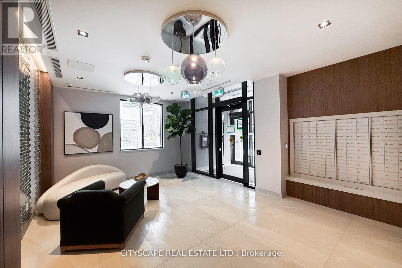 A modern living room with a black sofa and a wooden cabinet.