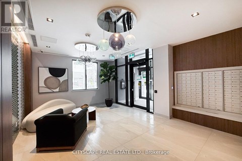 A modern living room with a black sofa and a wooden cabinet.