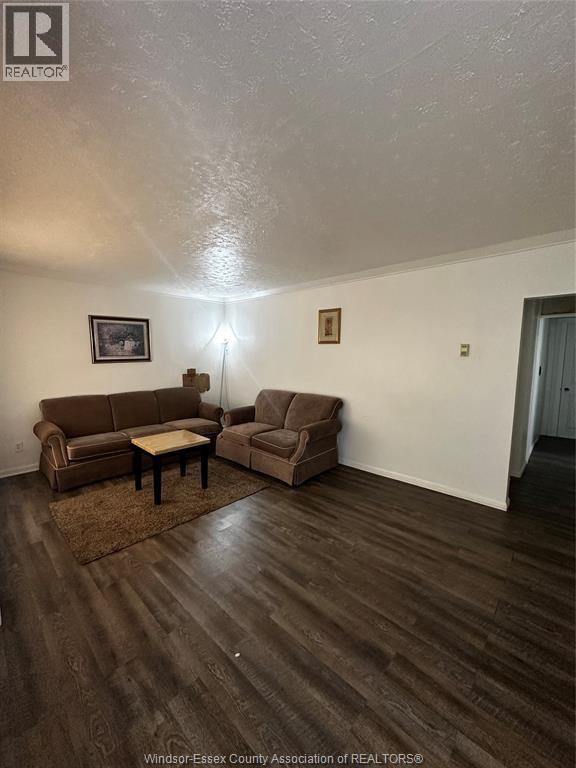 A living room with a couch, chair, and coffee table.