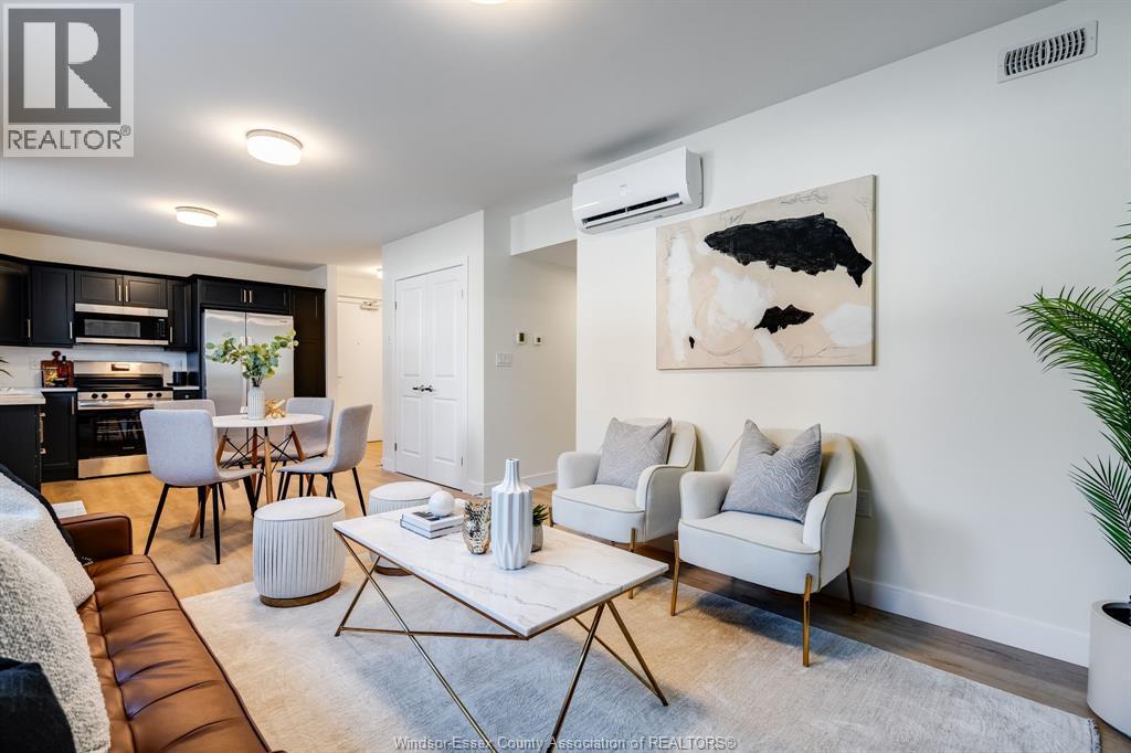 A modern living room with a brown leather couch and a white coffee table.