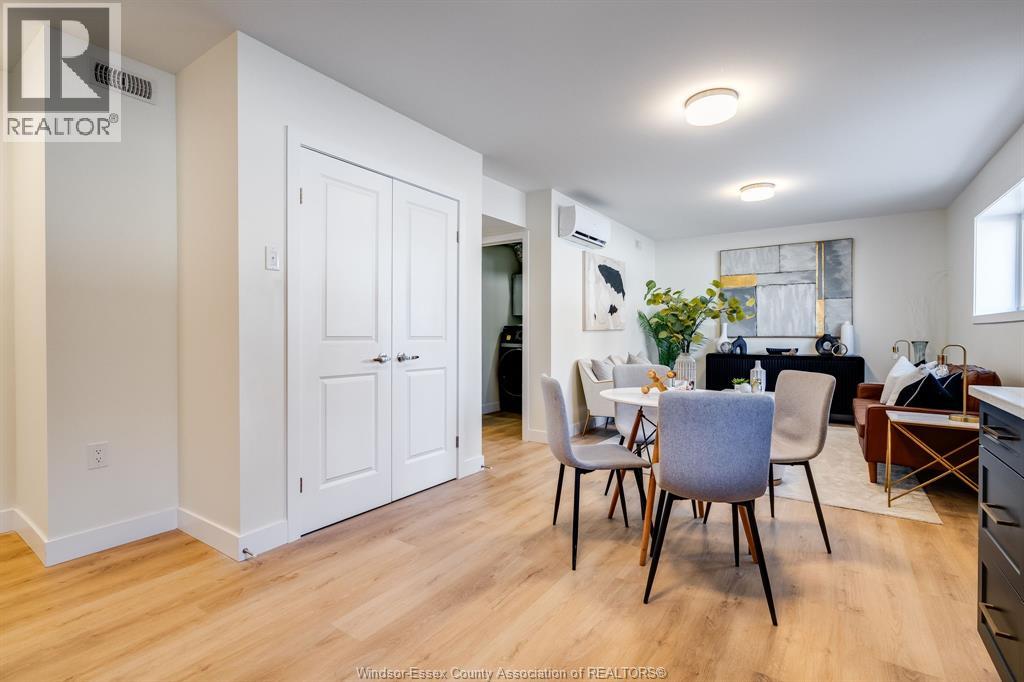 A dining room with a table and chairs.