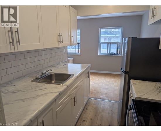 A kitchen with a sink and cabinets.