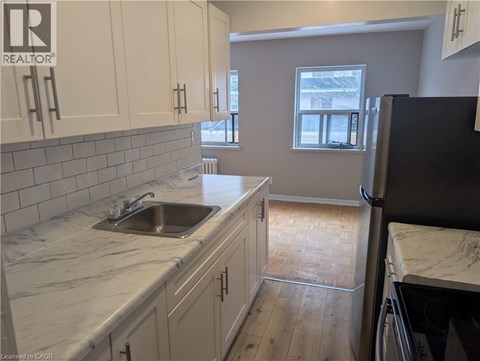 A kitchen with a sink and cabinets.