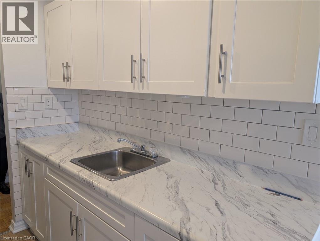 A kitchen with a sink and cabinets.