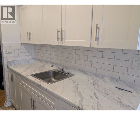 A kitchen with a sink and cabinets.