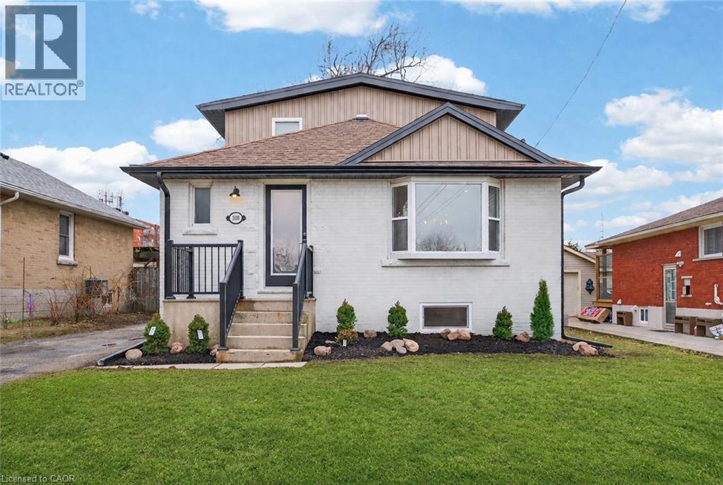 A house with a brown roof and a white front is for sale.