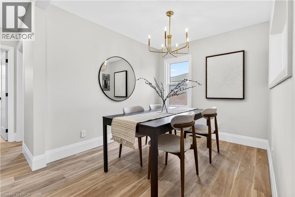 A dining room with a wooden table and chairs.