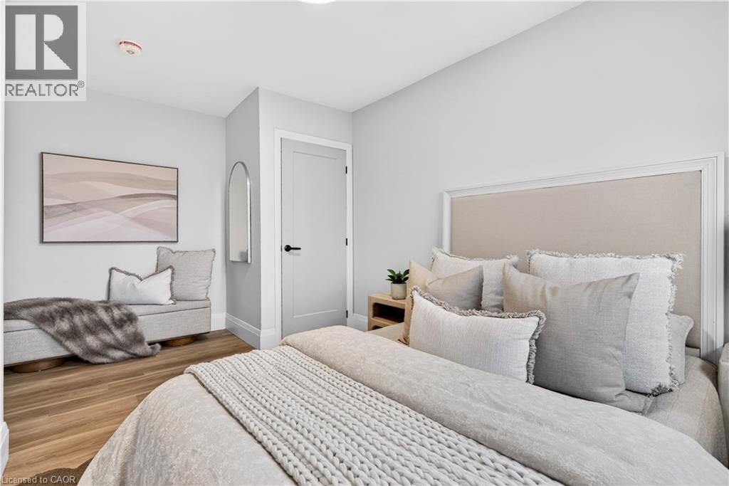 A bedroom with a large bed and a painting on the wall.
