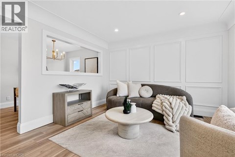 A living room with a grey couch and a white coffee table.