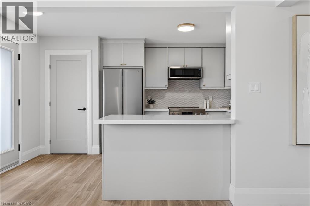 A kitchen with white cabinets and a white island.
