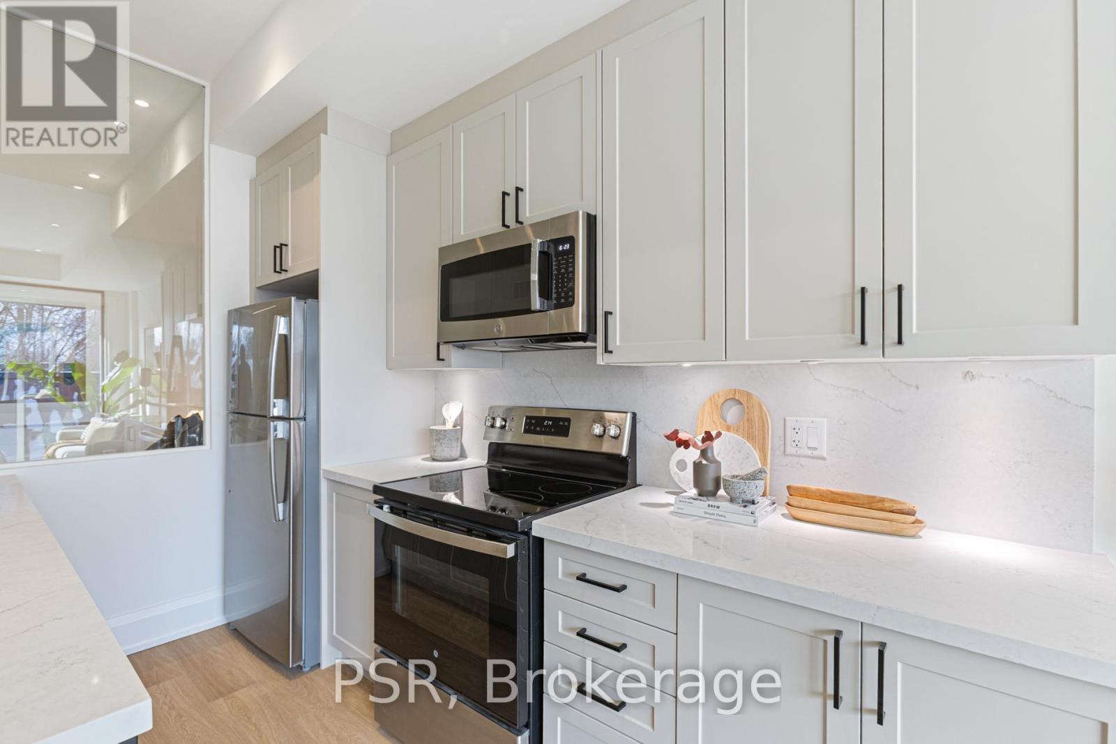 A kitchen with white cabinets and appliances is on the market.