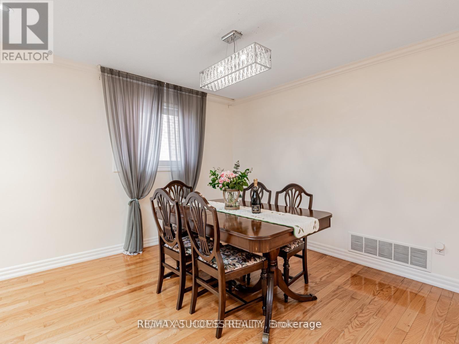 A dining room with a wooden table and chairs.