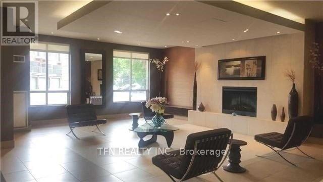 A living room with a fireplace and a dining table.