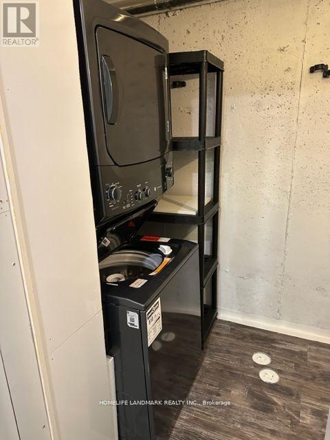A white oven with a black door is installed in a kitchen.