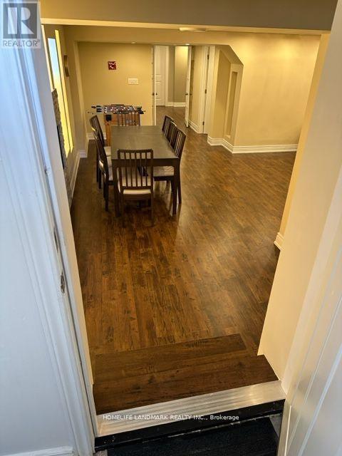 A dining room with a wooden table and chairs.