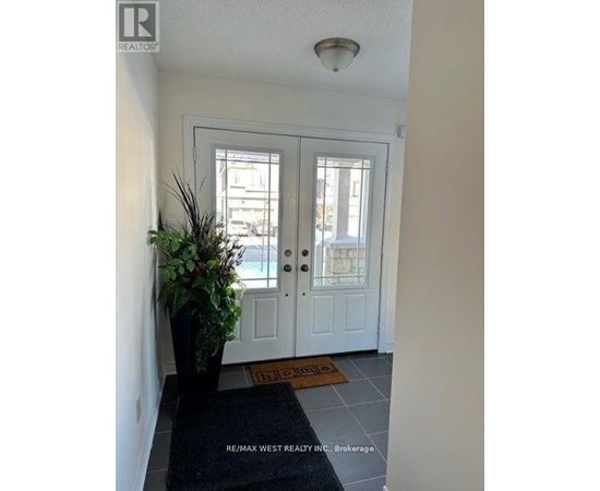 A white door with a glass window is flanked by two windows on either side.