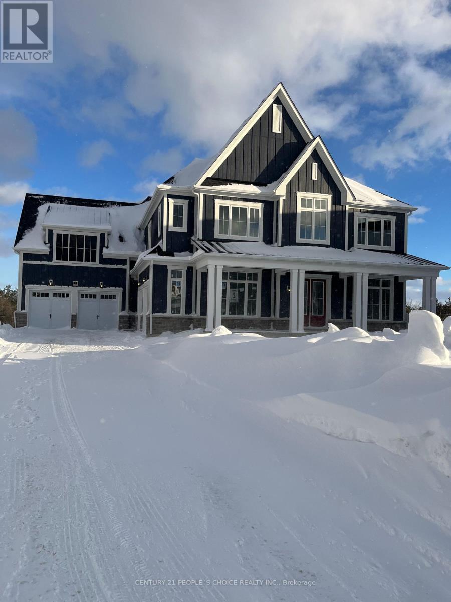 A large house with a snowy front yard.
