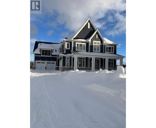 A large house with a snowy front yard.