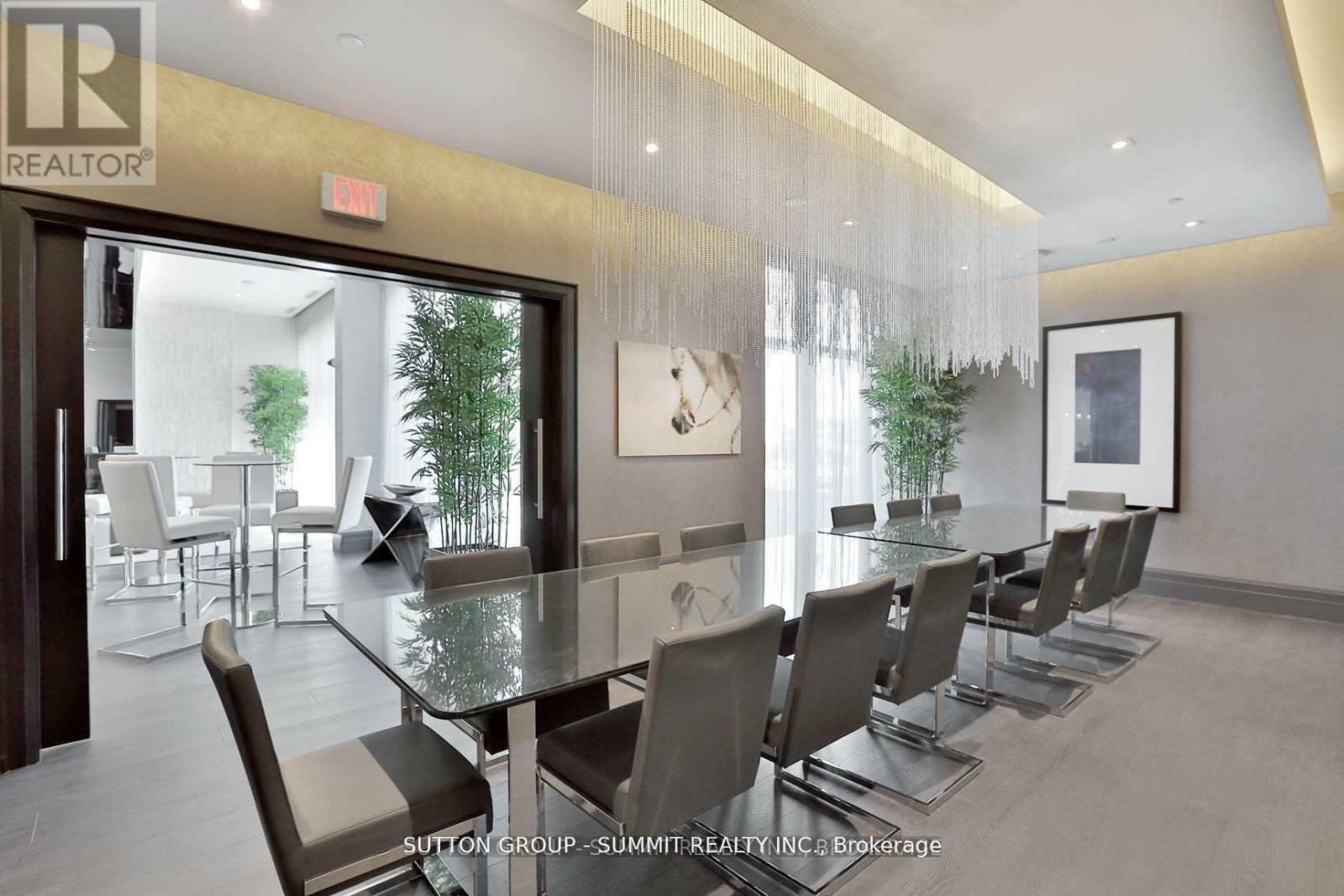 A dining room with a glass table and chairs.