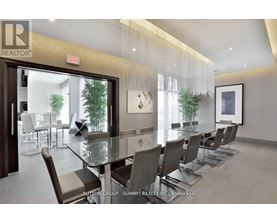 A dining room with a glass table and chairs.
