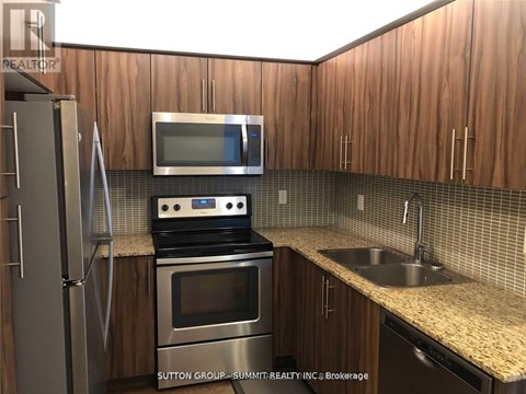 A kitchen with wooden cabinets and stainless steel appliances.