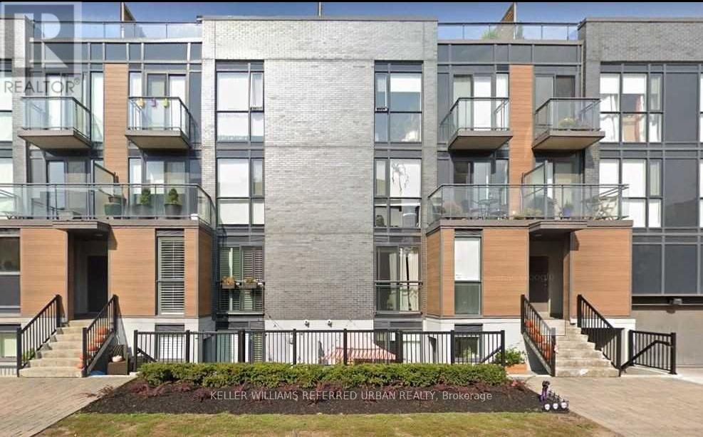 A modern apartment building with a sign that reads "KELLER WILLIAMS REFERENCED URBAN REALTY, Brokerage".