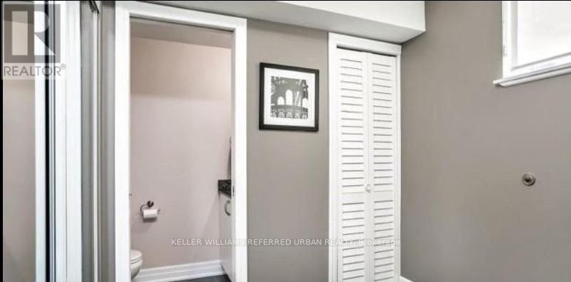 A bathroom with a toilet and a white door.