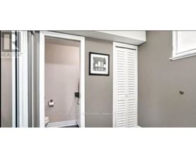 A bathroom with a toilet and a white door.