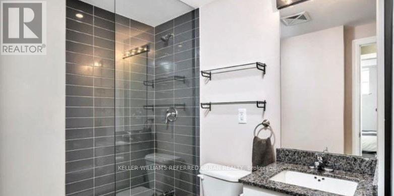 A bathroom with a shower and sink.