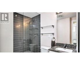 A bathroom with a shower and sink.