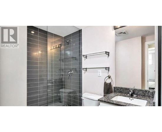 A bathroom with a shower and sink.