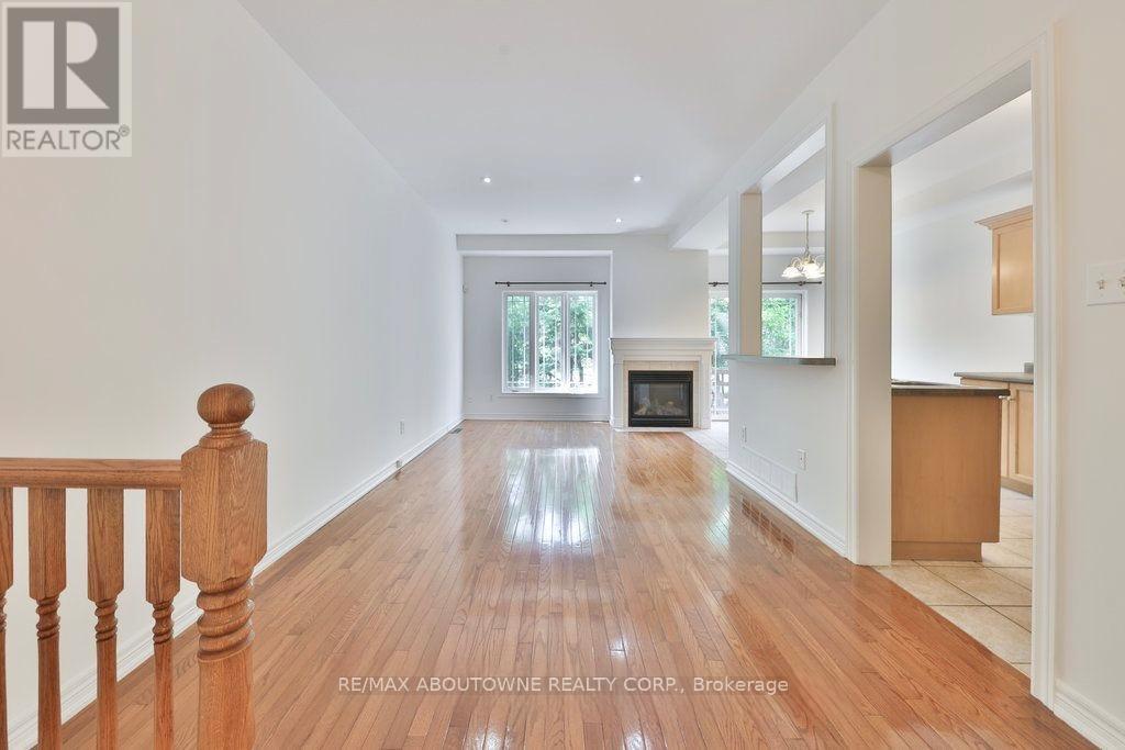 A spacious room with wooden floors and white walls.