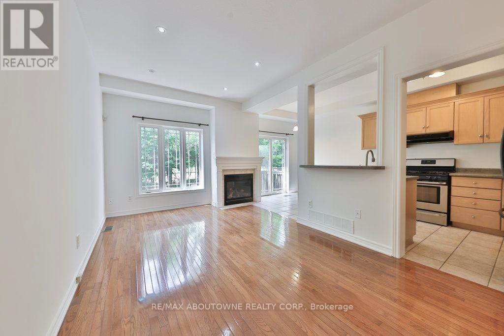 A spacious living room with hardwood floors and a fireplace.