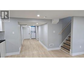 A hallway with a staircase leading to the second floor.