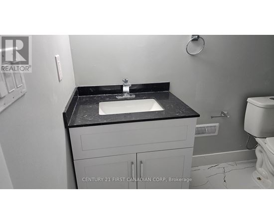 A bathroom with a sink and toilet.