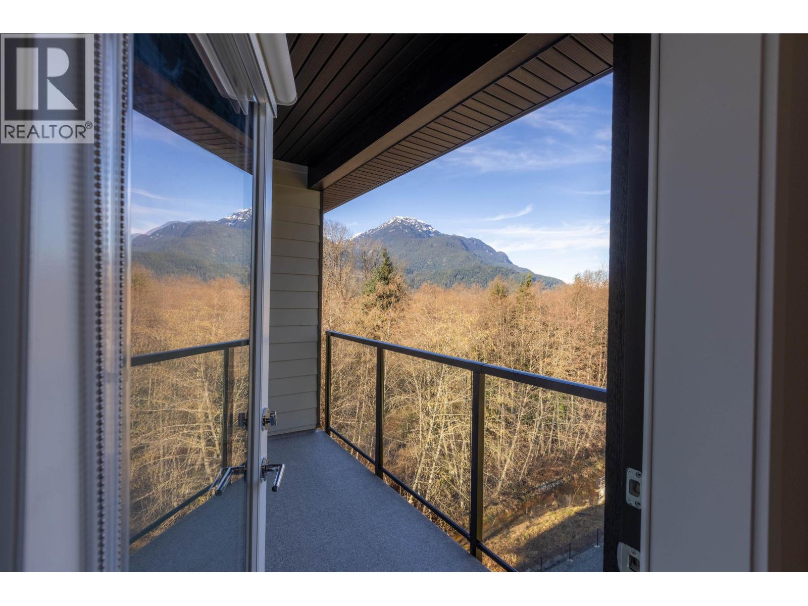 A balcony with a mountain view in the distance.