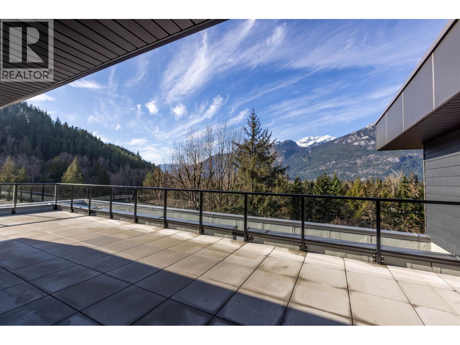 A balcony with a view of a mountain range.