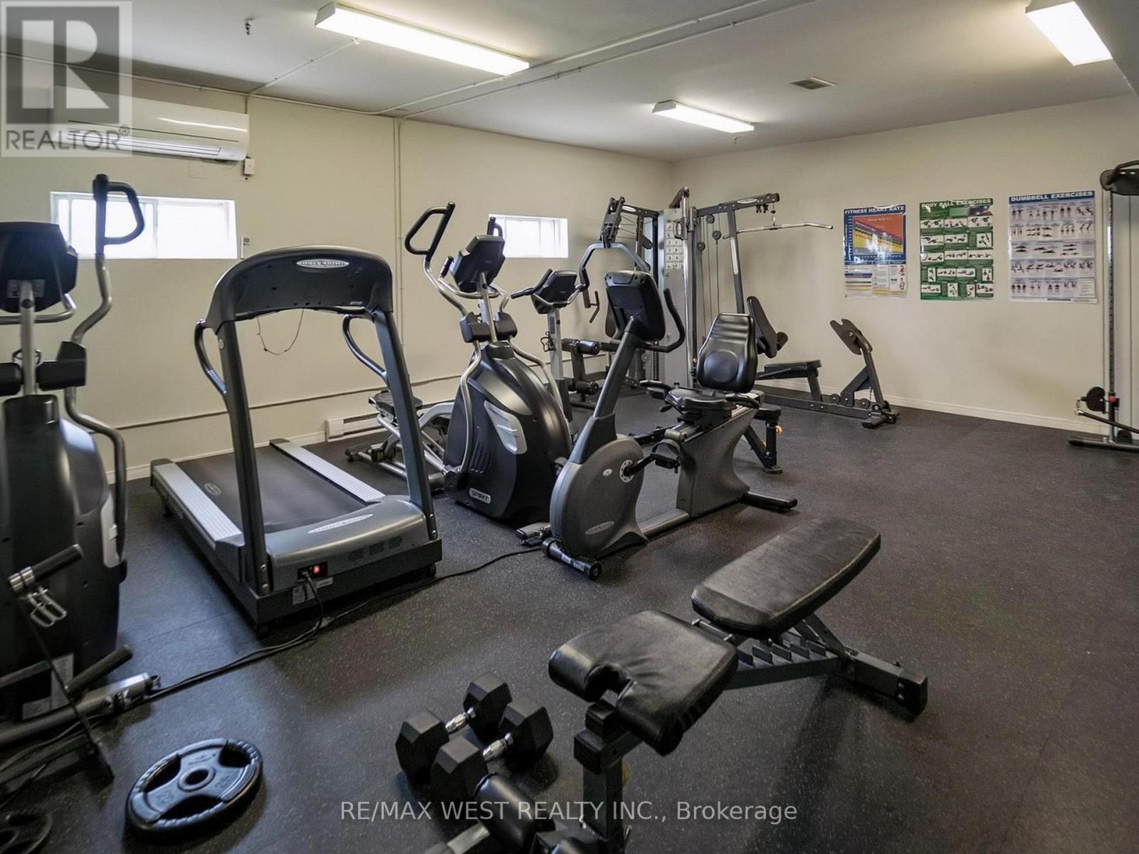 A gym with treadmills, weights, and exercise equipment.