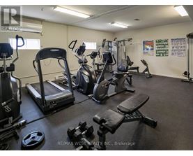A gym with treadmills, weights, and exercise equipment.