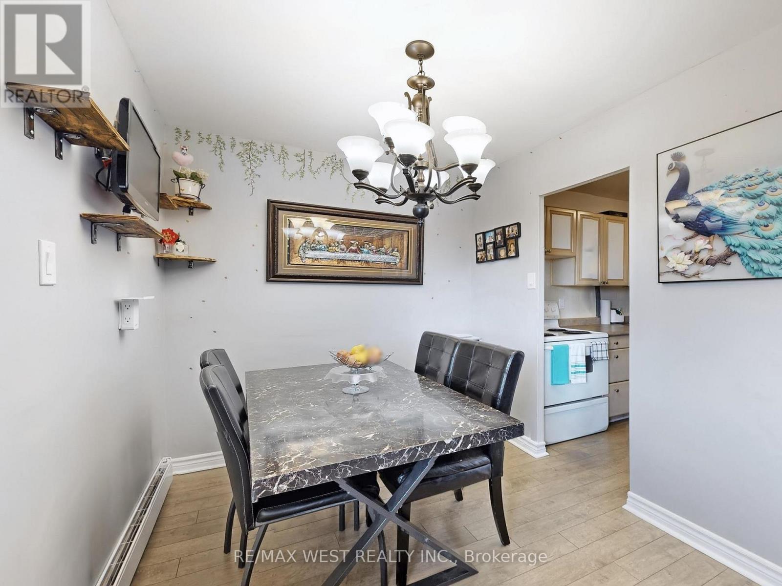 A dining room with a table and chairs.