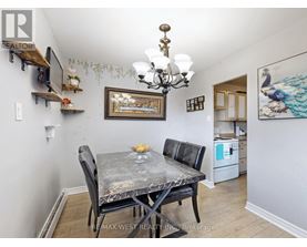 A dining room with a table and chairs.