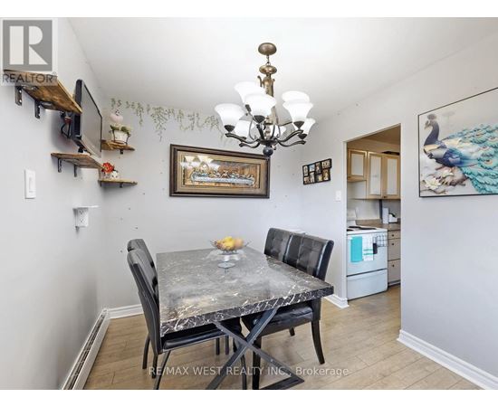 A dining room with a table and chairs.