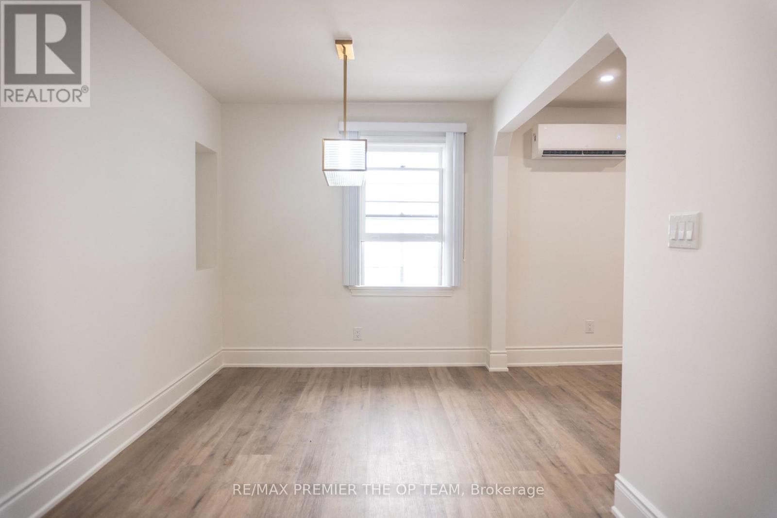 A room with a window and a light fixture.