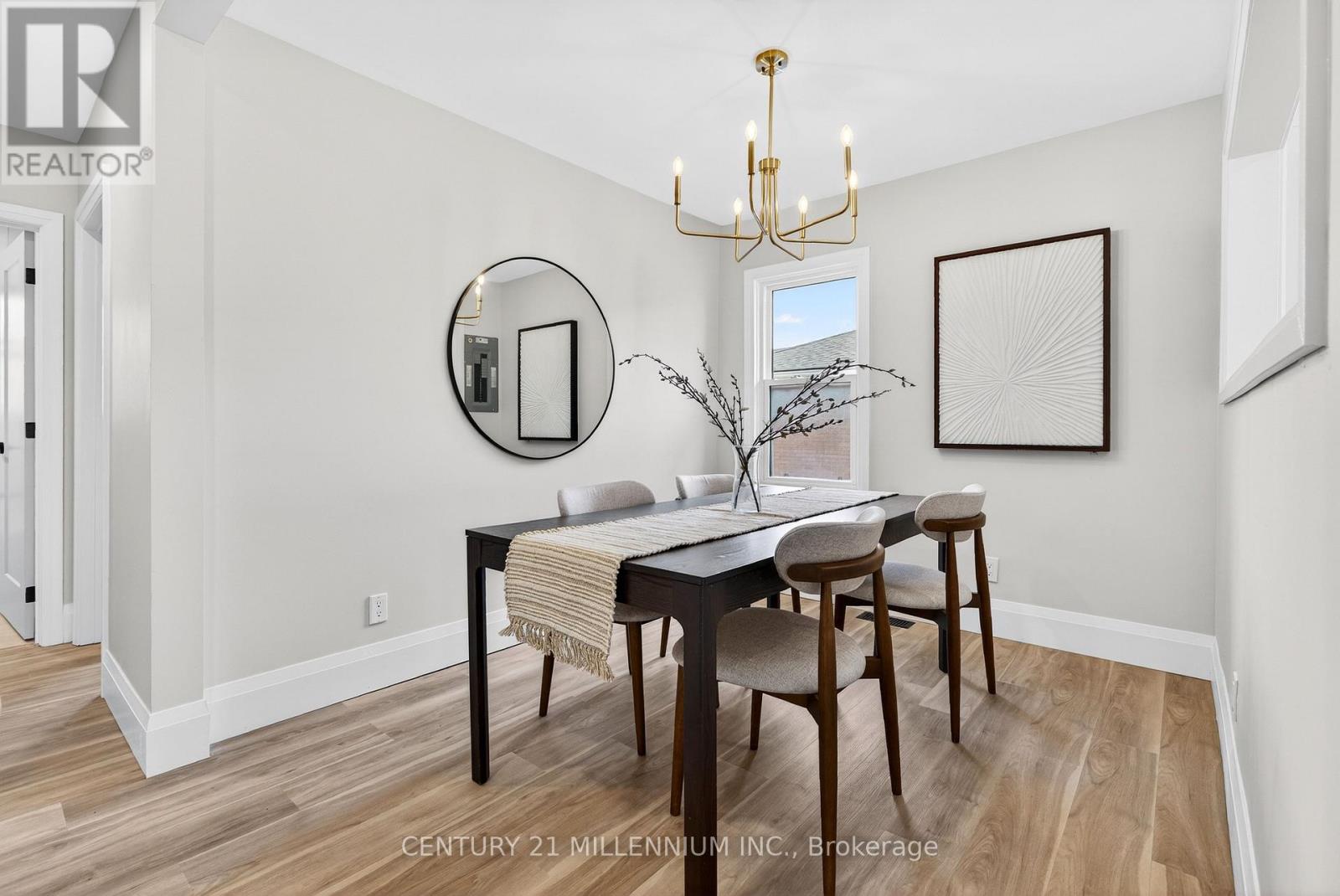 A dining room with a wooden table and chairs.