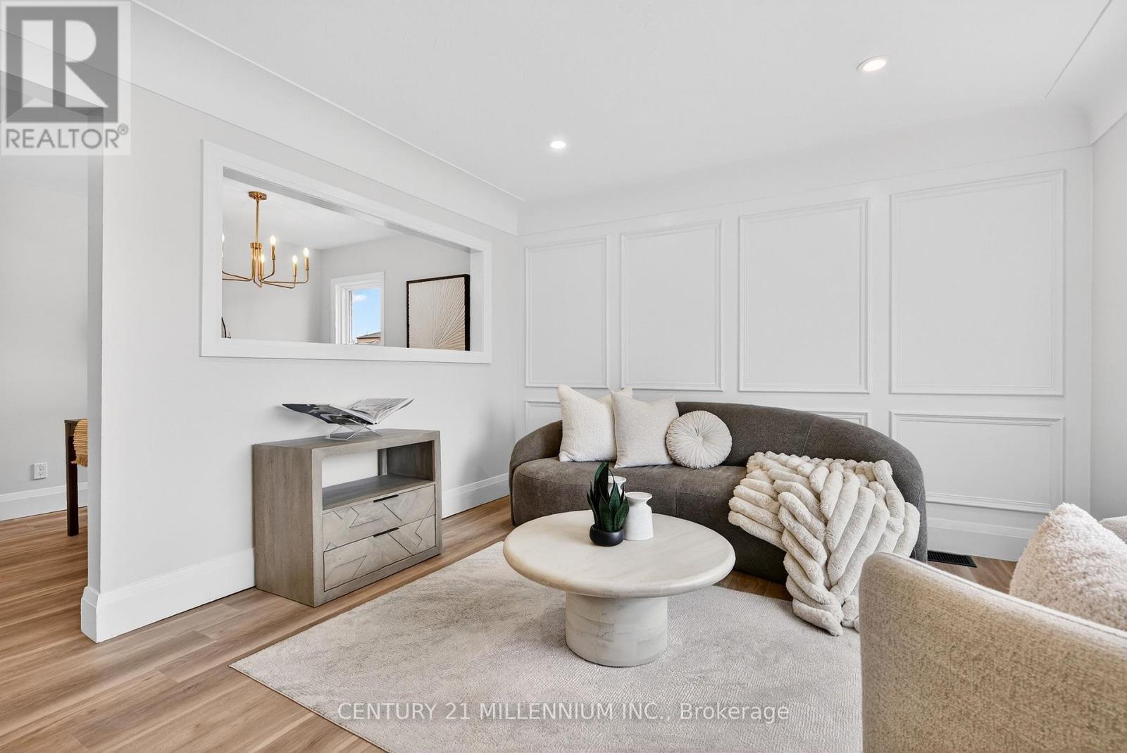 A living room with a grey couch and a white coffee table.