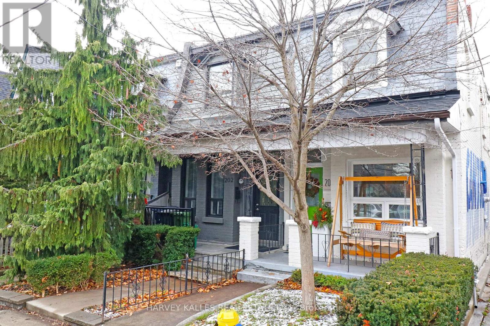 A house with a front yard and a tree.